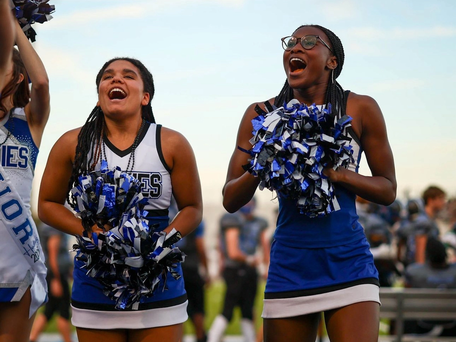 Poms in use by cheerleaders